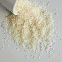 dry long grain rice spilling out of a cup