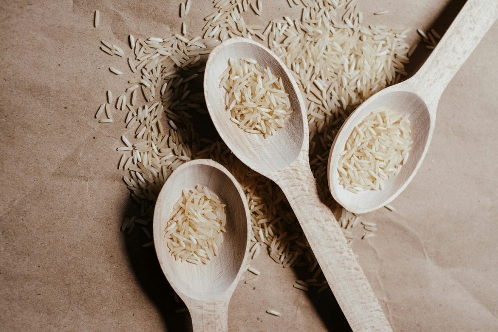 three wooden spoons with grains of rice