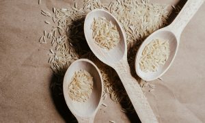 three wooden spoons with grains of rice
